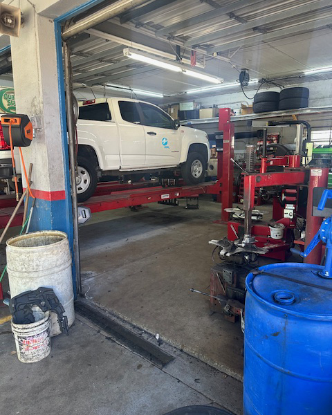 White truck in garage for alignment | Military Brake & Alignment Services Inc.